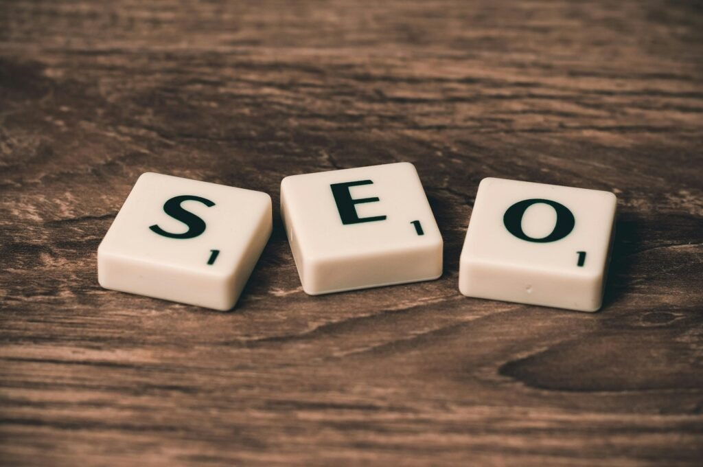 How to Write for SEO Without Sounding Like a Robot Scrabble tiles spelling 'SEO' on a wooden surface. Ideal for digital marketing themes.