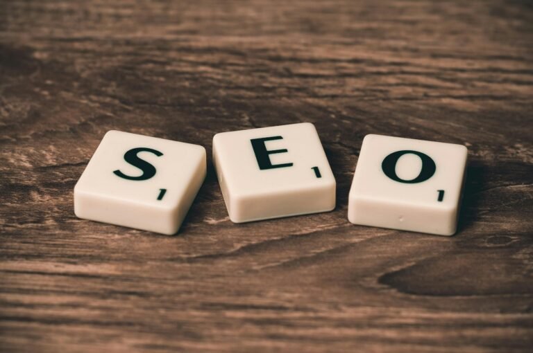 Blog Scrabble tiles spelling 'SEO' on a wooden surface. Ideal for digital marketing themes.