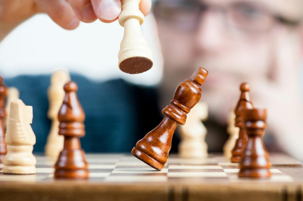 Build a B2B content strategy that matches buyers journey Close-up of a chess game with a focused player, emphasizing strategy and competition.